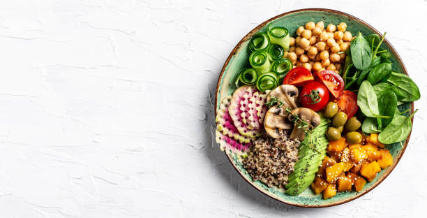 istock Buddha Bowl with Quinoa, Avocado, mushrooms, cucumber, chickpeas, spinach, tomatoes, vegetables salad. Clean eating, dieting, vegan food concept. top view 1455308548