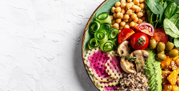 istock Buddha Bowl with Quinoa, Avocado, mushrooms, cucumber, chickpeas, spinach, tomatoes, vegetables salad. Clean eating, dieting, vegan food concept. top view 1455308552