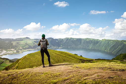 Rear view of a young woman in front of the caldera on São Miguel island in the Azores.