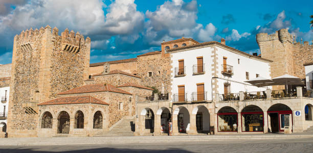 view of the main square of cáceres with the medieval tower of the twelfth century of bujaco, spain - caceres imagens e fotografias de stock