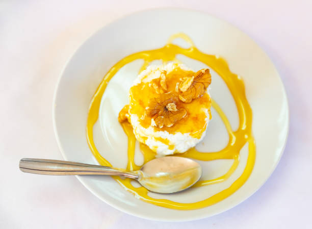 istock Catalan whey cheese, mato, served on plate with honey and walnuts 1455312214