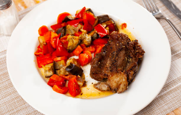 istock Delicious roasted pork chop served with stewed vegetables closeup 1455312852