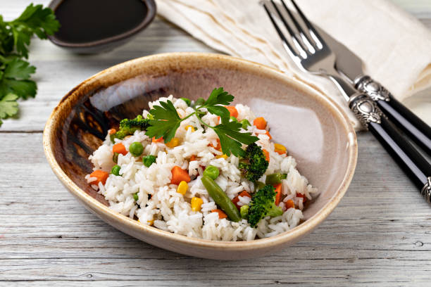 istock Bowl with tasty rice and vegetables 1455314662