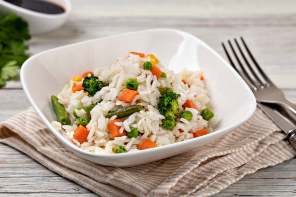 istock Bowl with tasty rice and vegetables 1455314672