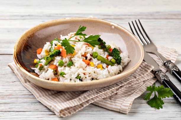 istock Bowl with tasty rice and vegetables 1455314696