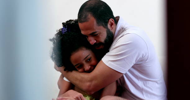 istock Candid father and daughter hug, black mixed race ethnicity 1455316304