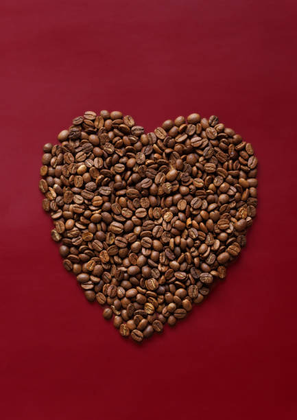 Istanbul, Turkey-January 8, 2023:  Heart shape made with roasted coffee beans on a red background. Valentine's Day concept. Shot with Canon EOS R5.