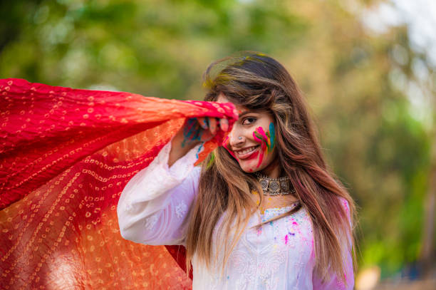 istock A beautiful girl celebrating holi with colours 1455317163