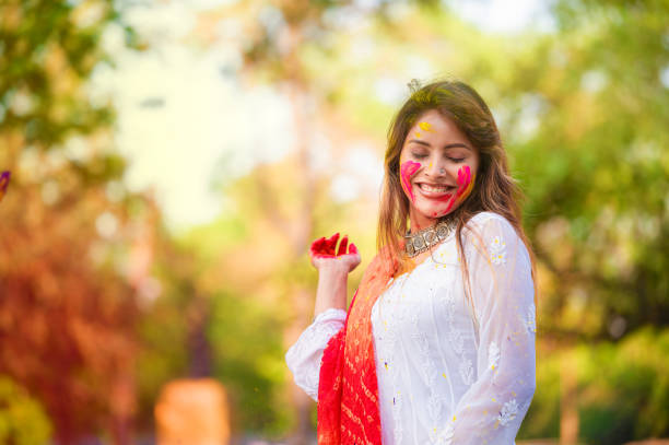 istock A beautiful girl celebrating holi with colours 1455317233