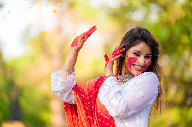 istock A beautiful girl celebrating holi with colours 1455317234