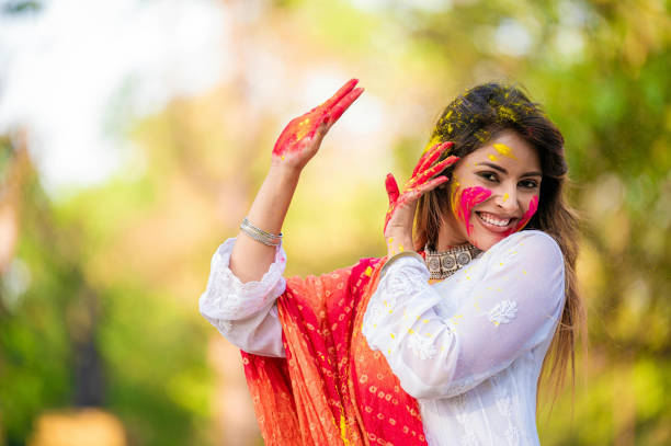 istock A beautiful girl celebrating holi with colours 1455317237