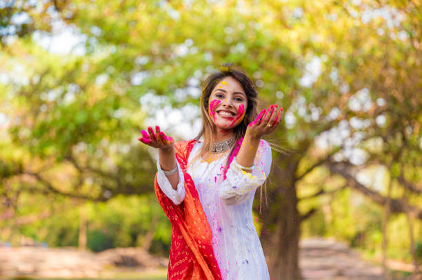 istock A beautiful girl celebrating holi with colours 1455317255