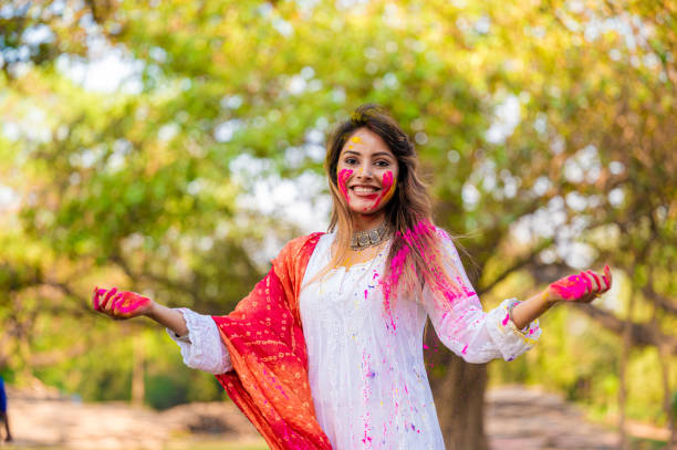 istock A beautiful girl celebrating holi with colours 1455317259