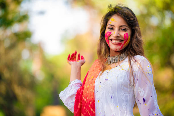 istock A beautiful girl celebrating holi with colours 1455317262