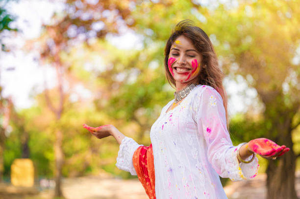 istock A beautiful girl celebrating holi with colours 1455317268