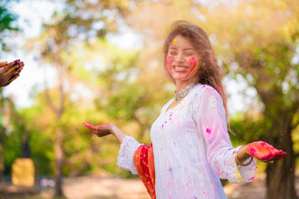 istock A beautiful girl celebrating holi with colours 1455317280