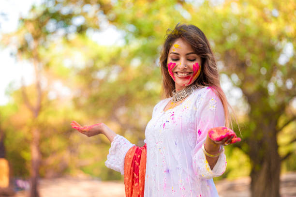 istock A beautiful girl celebrating holi with colours 1455317356