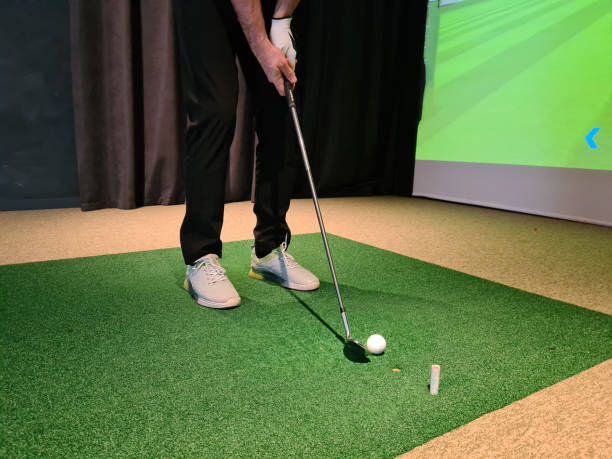 istock Golf player playing golf indoors on golf simulator closeup 1455317529