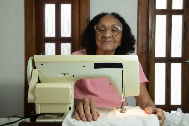 istock brazilian elderly woman using sewing machine 1455318730