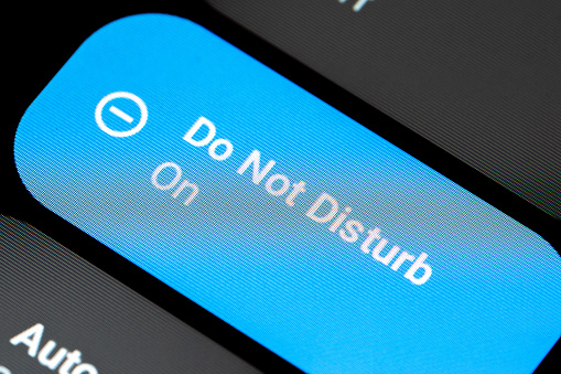 Close-up of a smartphone device screen showing the DND Do not Disturb mode being enabled