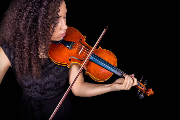 istock Violin player. Black violinist playing hands close up isolated 1455321113