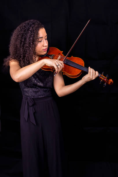 istock Beautiful young black woman playing violin 1455321124
