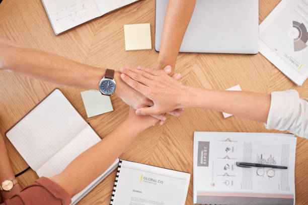 istock Teamwork, hands together and business people in meeting for data analysis, planning and project development strategy at table with document or report. Men and women collaboration and motivation group 1455322335