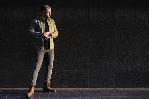 A young handsome stylish Caucasian man looking away