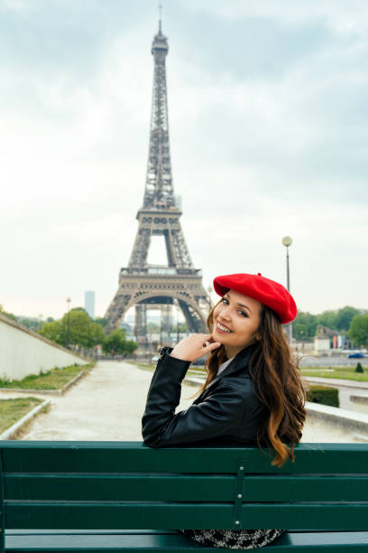 istock Beautiful young woman visiting paris and the eiffel tower 1455325424