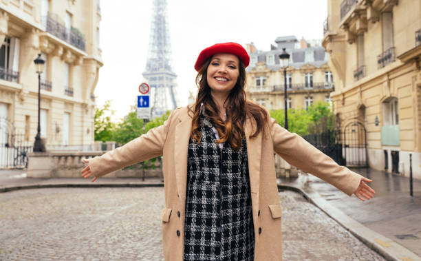istock Beautiful young woman visiting paris and the eiffel tower 1455326020