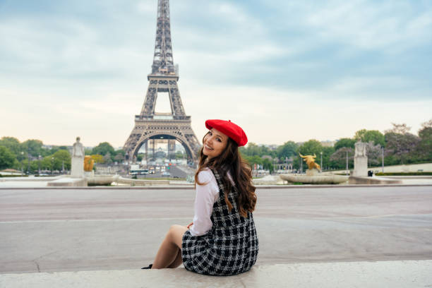 istock Beautiful young woman visiting paris and the eiffel tower 1455326159