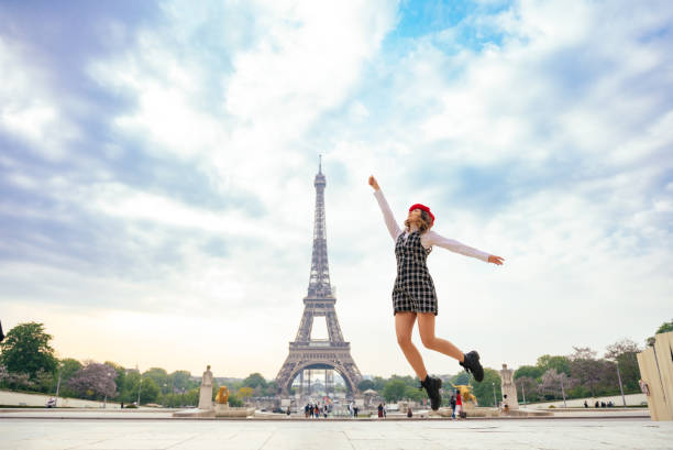 istock Beautiful young woman visiting paris and the eiffel tower 1455326315