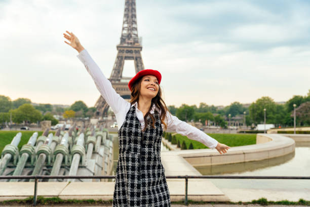 istock Beautiful young woman visiting paris and the eiffel tower 1455326449