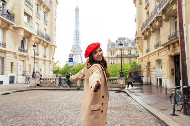 istock Beautiful young woman visiting paris and the eiffel tower 1455326602