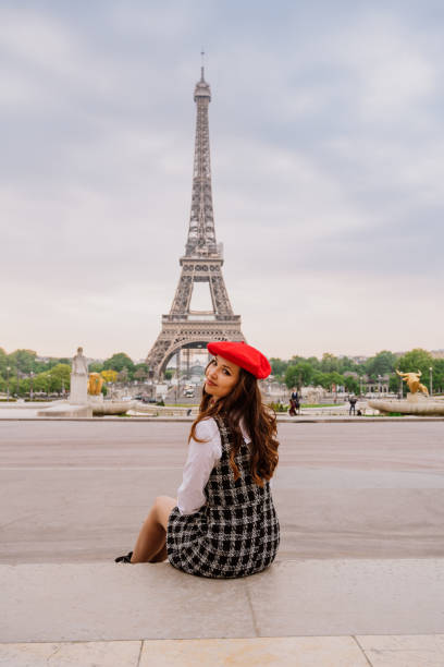 istock Beautiful young woman visiting paris and the eiffel tower 1455326902