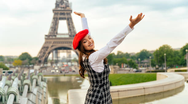istock Beautiful young woman visiting paris and the eiffel tower 1455327036