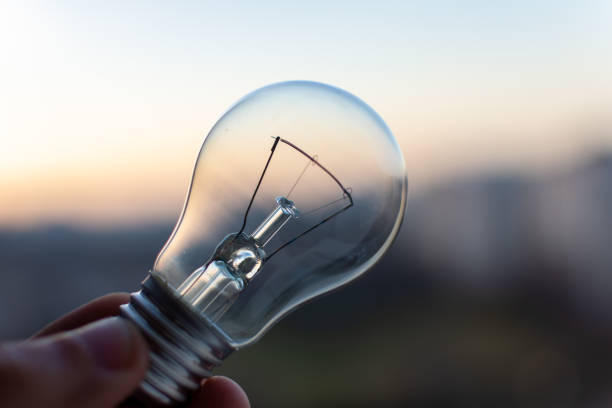 istock Edisonon light bulb on city sunset background 1455327137