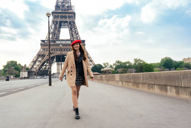 istock Beautiful young woman visiting paris and the eiffel tower 1455328244