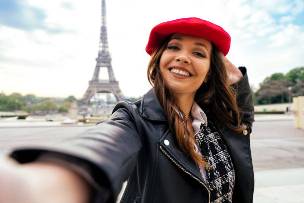 istock Beautiful young woman visiting paris and the eiffel tower 1455328499
