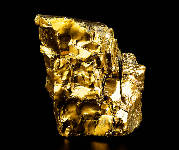 istock Single gold nugget on a black background. Close up the gold ore. 1455332443