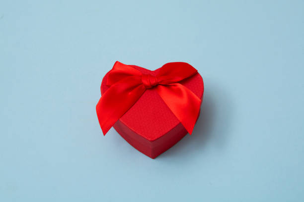 istock Red heart shape decorative gift box with red bow on pastel blue background. Valentines day, love, wedding, thanks giving day, birthday top view. 1455336283
