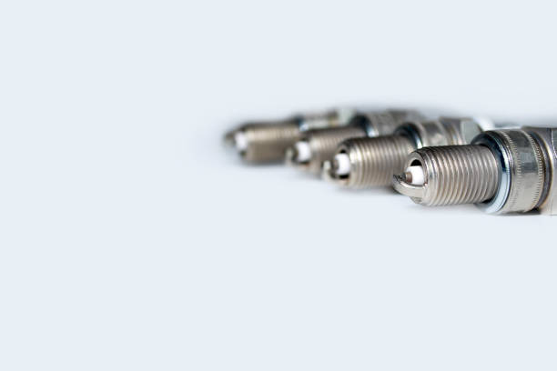istock spark plugs on white background with copy space and reflection. auto spare parts on white background 1455337236