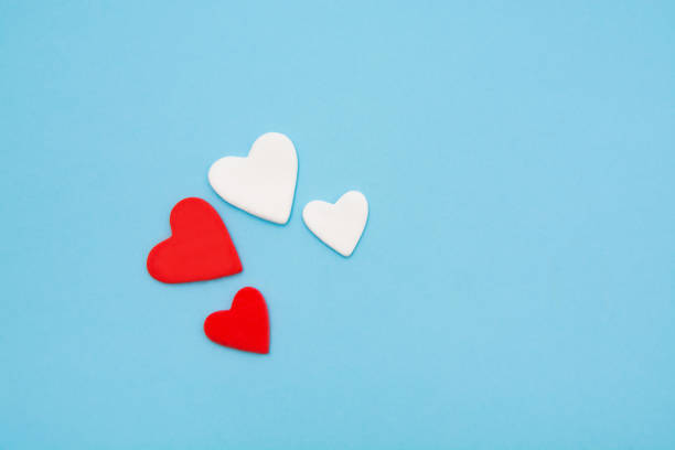 istock Red and white hearts on a pastel blue background. Minimal creative concept. A symbol of motherly love. Valentine's Day. 1455337922