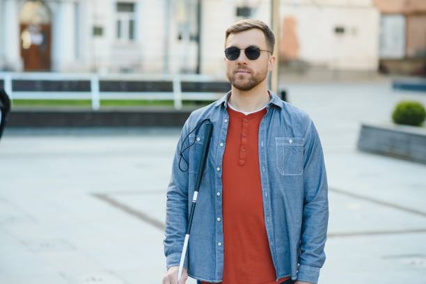 istock Handsome blind man walks around the city. 1455338960