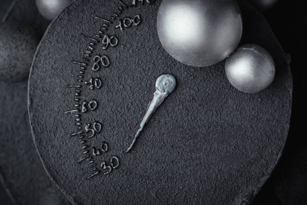 istock Anniversary black bunk cake with chocolate velvet coating isolated on black background. Birthday cake decorated with silver chocolate spheres and speedometer silhouette indicating age of 30 years 1455338995