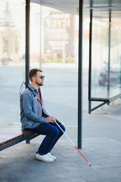 istock Blinded man waiting for bus at a bus station 1455339194
