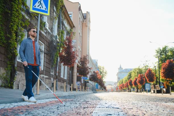 istock Blind young man crossing road 1455340048