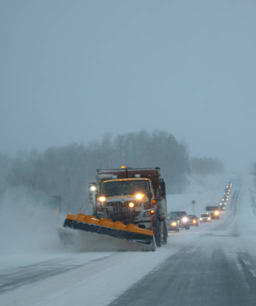 istock Snowplough in on busy road during snowsquall 1455340348