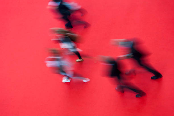 High angle view of blurred young people on red carped.