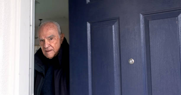 istock Serious Old hispanic man his home front door looking at the camera 1455342967
